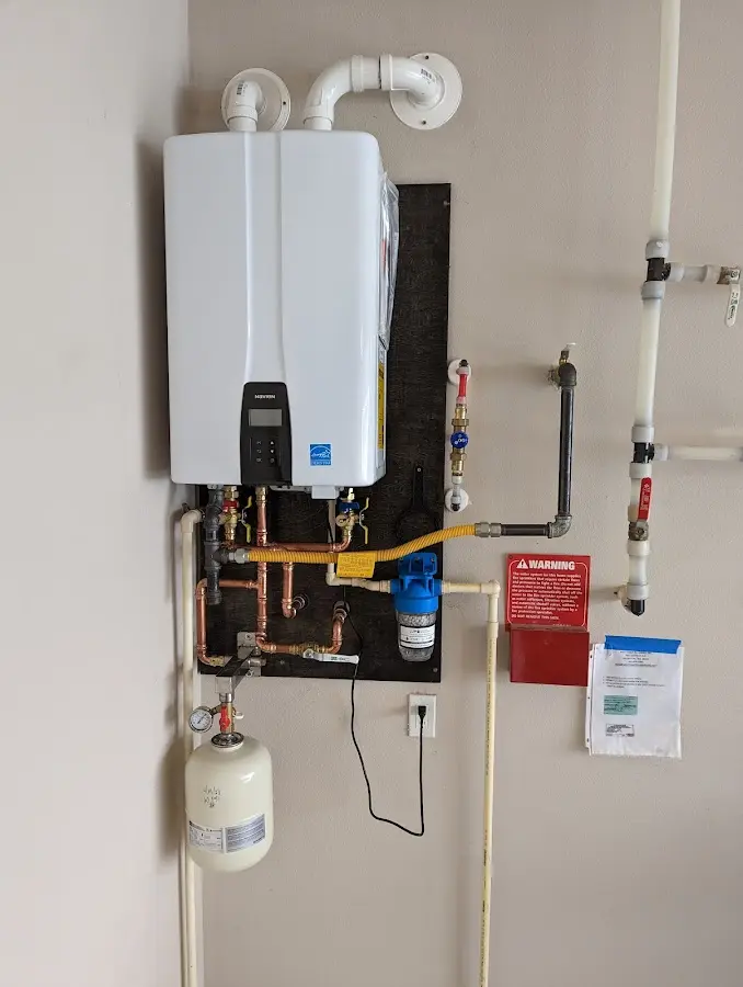 Professional plumber installing copper piping in a Matawan home